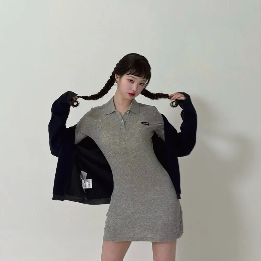 Jang Won-Young (IVE) mang váy thun xám đang cầm hai bím tóc.