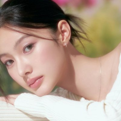 tế bào gốc - cô gái mặc áo tay dài màu trắng, tạo kiểu tóc búi thấp và chống cằm