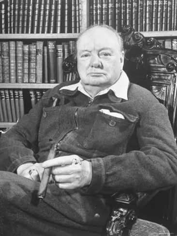 winston-churchill-holding-cigar-seated-in-study-at-chartwell-wearing-zippered-jumpsuit