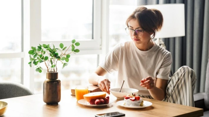 Cô gái ngồi ăn bữa sáng.