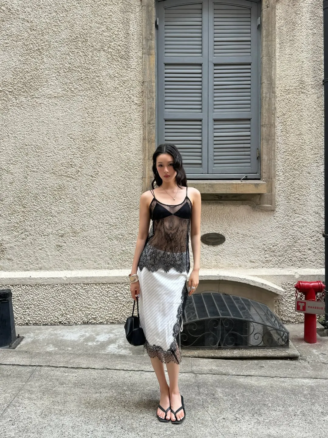 Chất liệu da cao cấp của đôi dép bệt xỏ ngón kết hợp cùng chân váy lụa ren, nhấn mạnh sự sang trọng trong sự giản đơn.